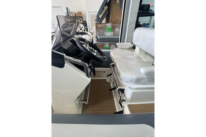 Slide: The Image of 2023 Williams Jet Tenders Dieseljet 445 interior with steering wheel and seating. - 4