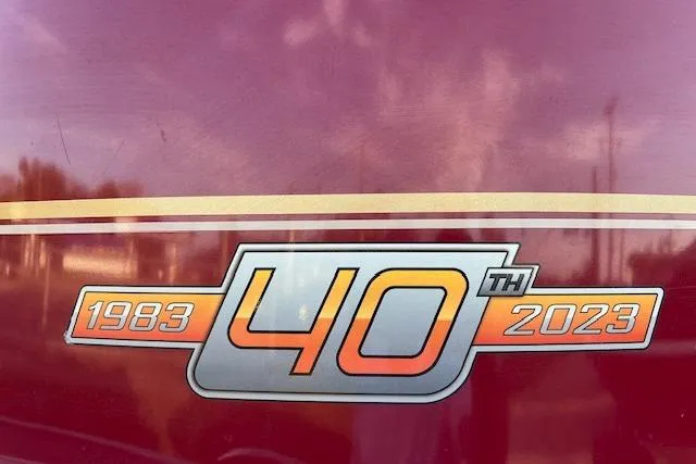 Slide: The Image of Sun Tracker Bass Buggy 18 DLX 40th Anniversary Edition, 1983-2023, logo on maroon background. - 3