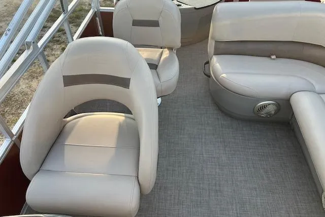 Slide: The Image of 2023 Sun Tracker Bass Buggy 18 DLX interior with beige seating and carpeted floor. - 6