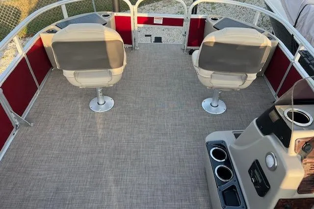 Slide: The Image of 2023 Sun Tracker Bass Buggy 18 DLX pontoon boat interior with seating and console. - 9