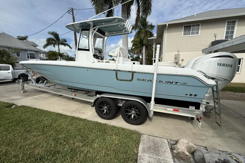 Slide: The Image of 2025 Sea Hunt Escape 28 boat on trailer, parked in residential driveway. - 12