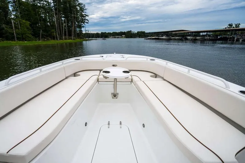 Slide: The Image of 2025 Sea Hunt Escape 28 boat interior with console, on calm water. - 3