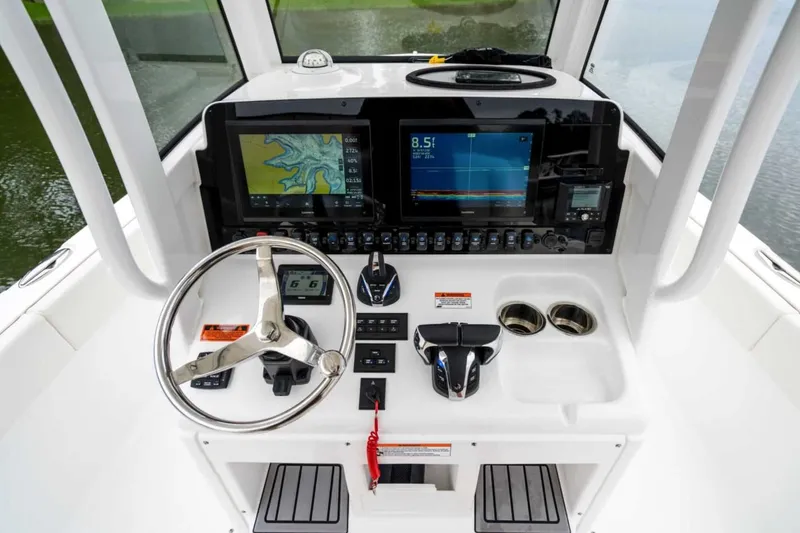 Slide: The Image of 2025 Sea Hunt Escape 28 boat with sleek design and spacious seating on calm water. - 4