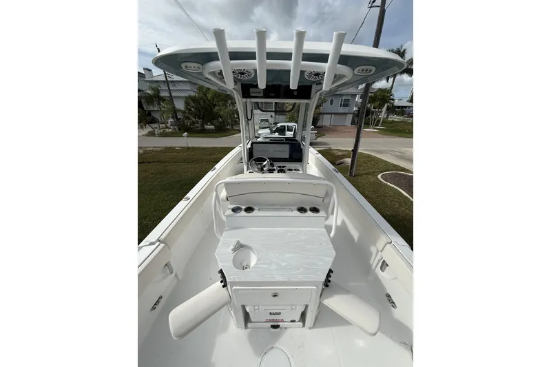 Slide: The Image of 2025 Sea Hunt Escape 28 boat interior with helm, seating, and rod holders. - 8