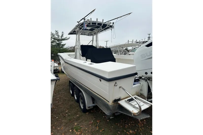 Slide: The Image of 2004 Ocean Master 31 Center Console boat with American flag on calm water. - 3