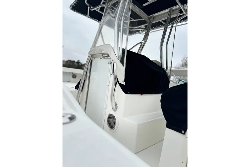 Slide: The Image of 2004 Ocean Master 31 Center Console boat docked, featuring spacious deck and helm. - 5