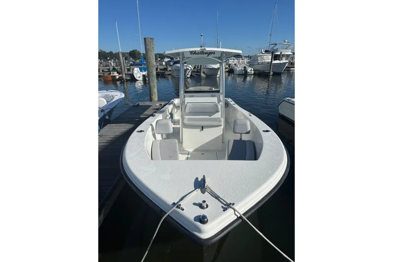 Slide: The Image of 2019 KenCraft 21 boat docked at marina, featuring spacious deck and seating. - 3