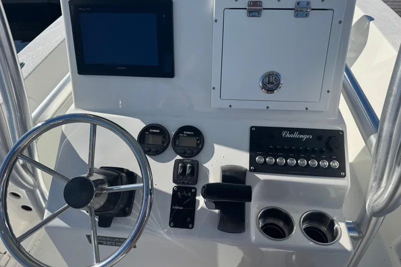 Slide: The Image of Control panel of a 2019 KenCraft 21 boat with steering wheel and gauges. - 5