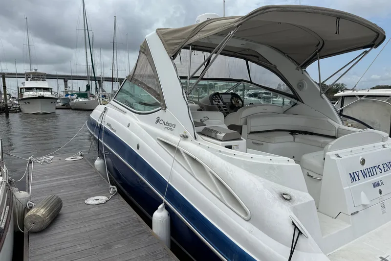 Slide: The Image of 2008 Cruisers Yachts 330 Express docked at marina under cloudy skies. - 2