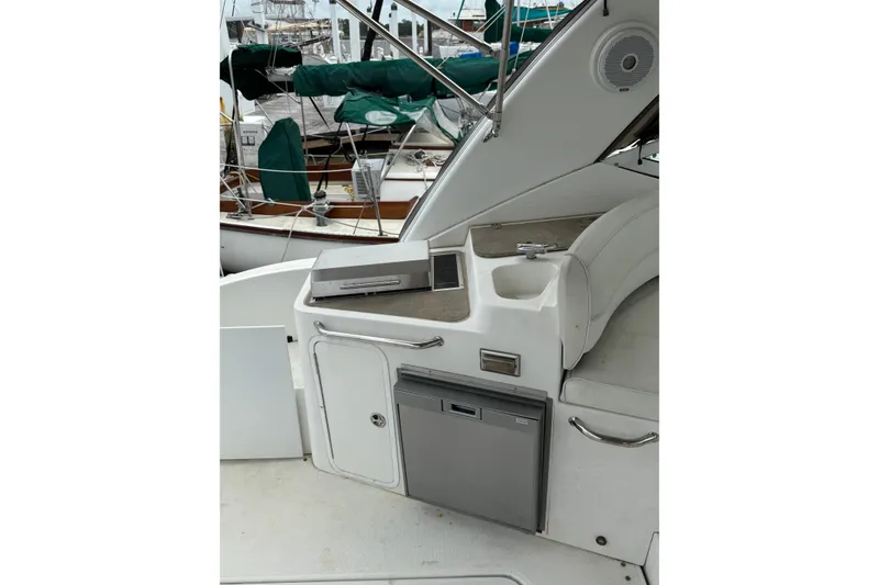 Slide: The Image of 2008 Cruisers Yachts 330 Express interior with kitchenette and seating area. - 4