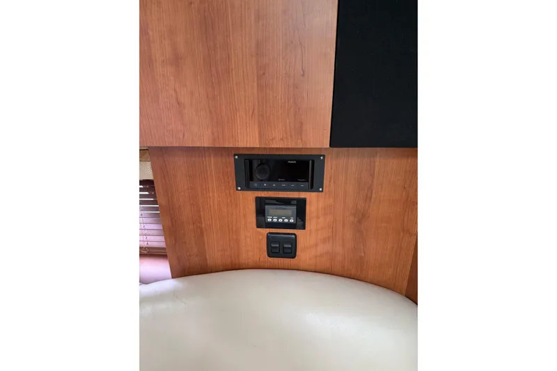 Slide: The Image of 2008 Cruisers Yachts 330 Express interior with wood paneling and control panel. - 8