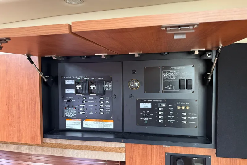 Slide: The Image of Electrical panel inside 2008 Cruisers Yachts 330 Express, featuring various switches and controls. - 9