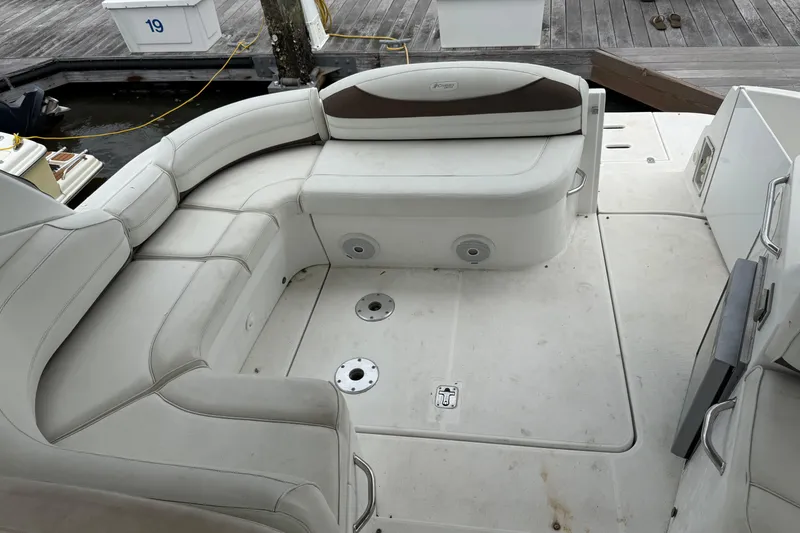 Slide: The Image of 2008 Cruisers Yachts 330 Express boat interior with white seating and dock view. - 10