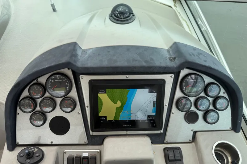 Slide: The Image of 2008 Cruisers Yachts 330 Express dashboard with Garmin navigation and gauges. - 11