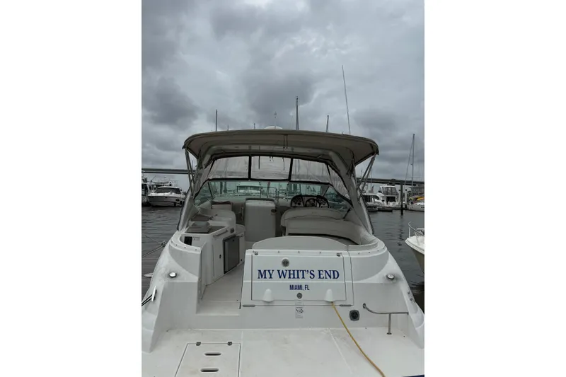 Slide: The Image of 2008 Cruisers Yachts 330 Express docked under cloudy skies, rear view. - 3