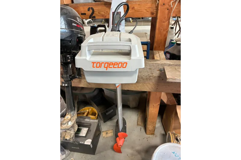 Slide: The Image of 2018 Torqeedo Travel 1003 S electric outboard motor in a workshop setting. - 0