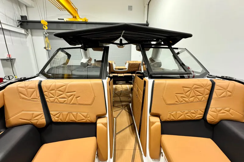 Slide: The Image of 2024 Nautique Super Air Nautique G23 Paragon interior with tan and black seating. - 11