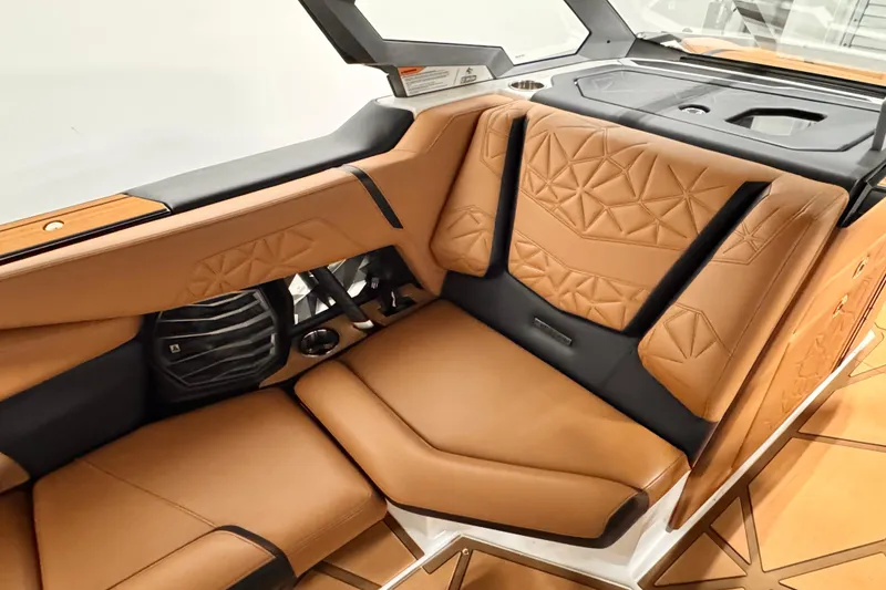 Slide: The Image of 2024 Nautique Super Air Nautique G23 Paragon interior with luxurious tan seating and geometric design. - 6