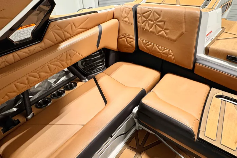 Slide: The Image of 2024 Nautique Super Air Nautique G23 Paragon interior with luxurious tan leather seating. - 7