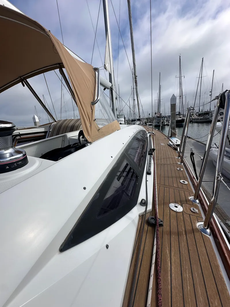 Slide: The Image of 2014 Jeanneau 57 yacht with teak deck, docked in marina. - 39