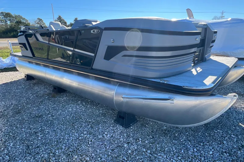 The Image of 2026 Sylvan R22 CLZ DH pontoon boat on gravel lot, side view. - 0