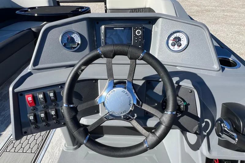 Slide: The Image of Steering console of 2026 Sylvan R22 CLZ DH boat with gauges and controls. - 11