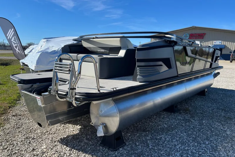 Slide: The Image of 2026 Sylvan R22 CLZ DH pontoon boat displayed outdoors on gravel. - 15