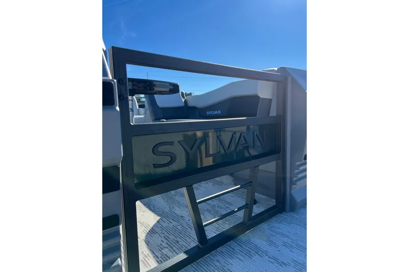 Slide: The Image of 2026 Sylvan R22 CLZ DH boat gate with logo under clear blue sky. - 2