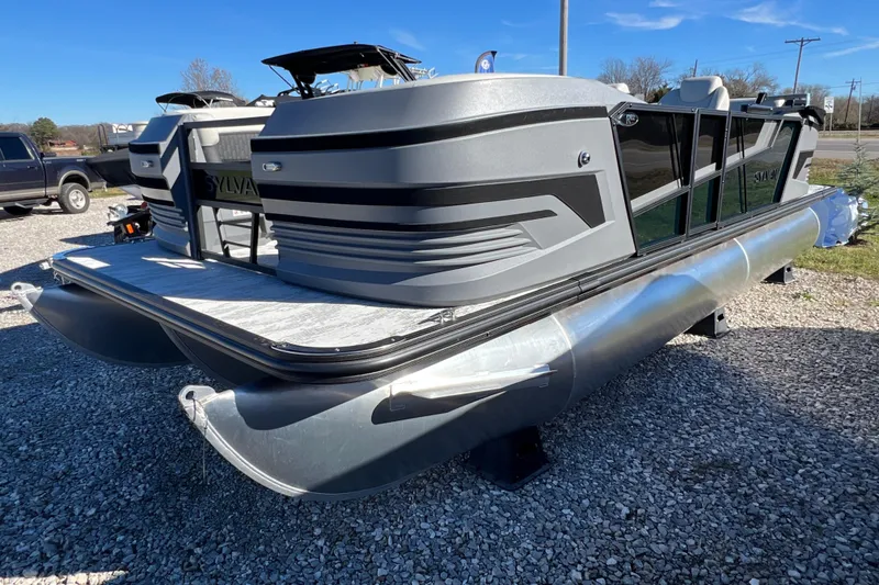 Slide: The Image of 2026 Sylvan R22 CLZ DH pontoon boat on gravel lot, rear view. - 4