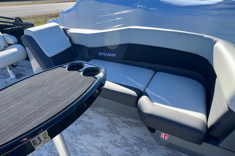 Slide: The Image of 2026 Sylvan R22 CLZ DH boat interior with cushioned seating and table. - 8