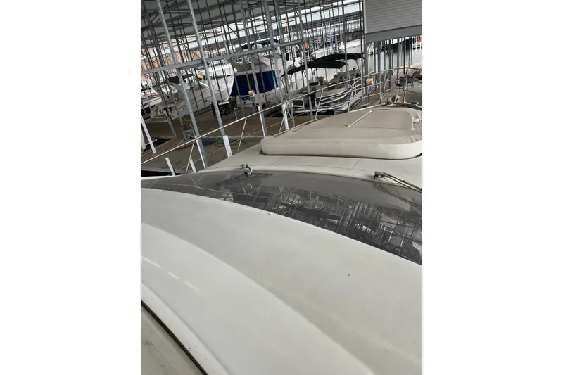 Slide: The Image of 2006 Azimut 68S yacht in marina, showcasing sleek design and spacious deck. - 7