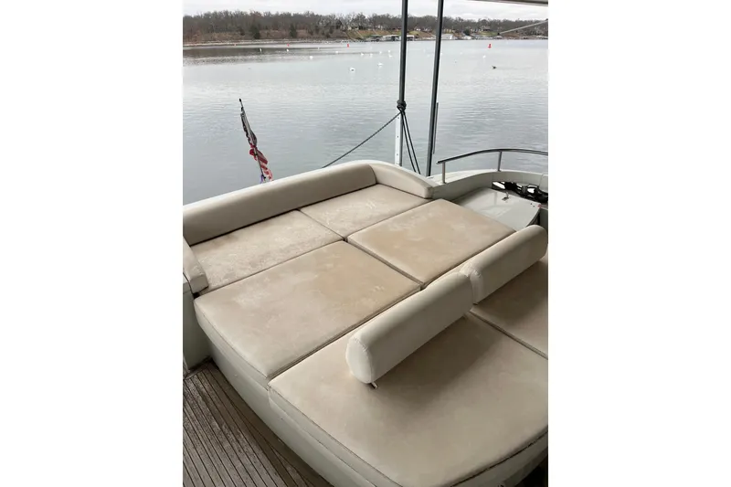 Slide: The Image of 2006 Azimut 68S yacht with spacious sunbathing deck overlooking serene waters. - 9