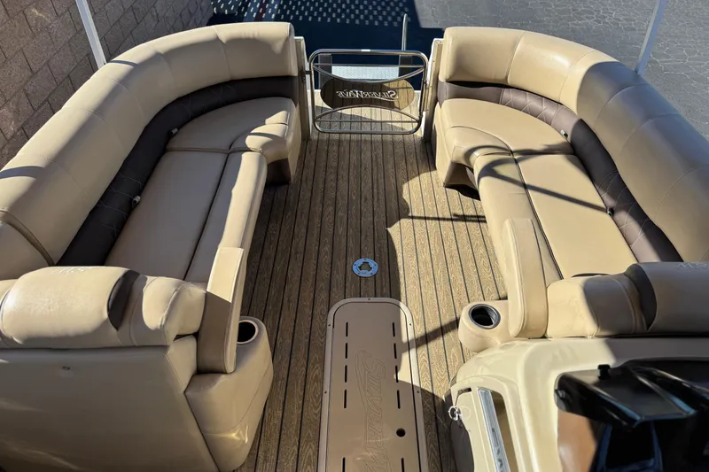 Slide: The Image of 2022 Silver Wave 2410 SW5 JS pontoon boat interior with beige seating and wood-style flooring. - 10