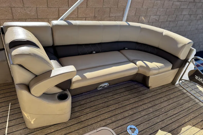 Slide: The Image of Luxurious seating on 2022 Silver Wave 2410 SW5 JS boat, featuring tan upholstery and cup holder. - 11
