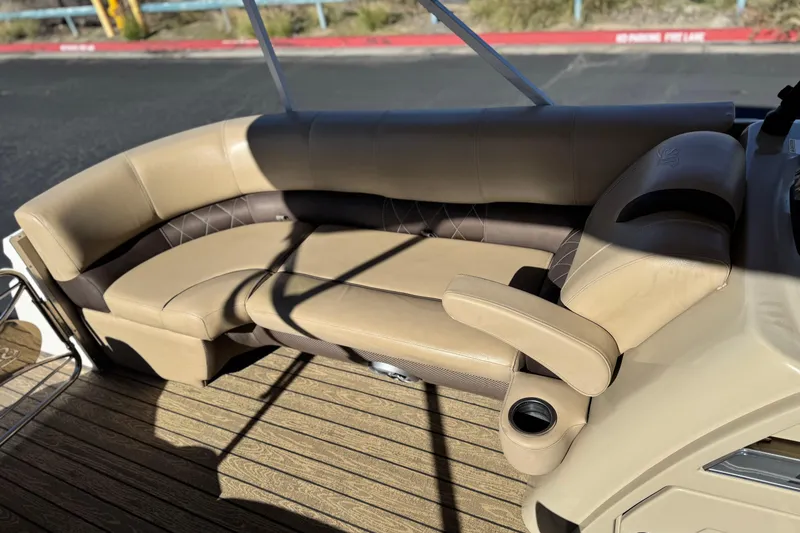 Slide: The Image of 2022 Silver Wave 2410 SW5 JS boat interior with beige seating and cup holder. - 12