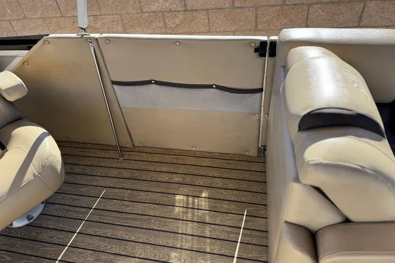 Slide: The Image of Interior of 2022 Silver Wave 2410 SW5 JS boat with beige seating and wood flooring. - 14