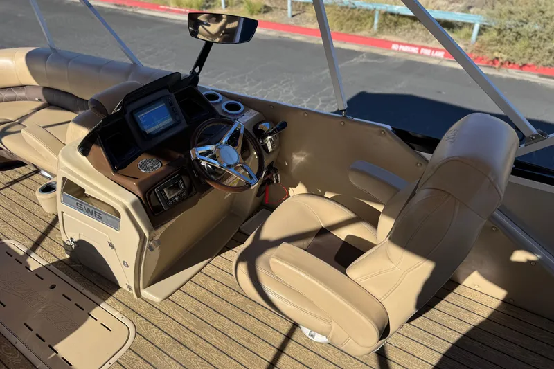 Slide: The Image of Interior of 2022 Silver Wave 2410 SW5 JS boat with beige seating and steering console. - 23