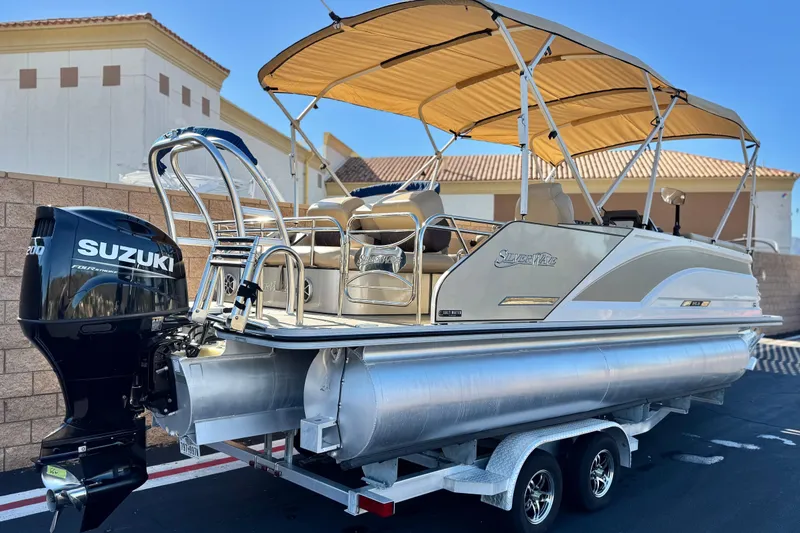 Slide: The Image of 2022 Silver Wave 2410 SW5 JS pontoon boat with Suzuki outboard motor on trailer. - 6