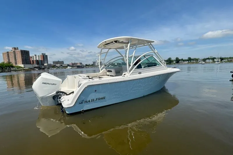 Slide: The Image of 2025 Sailfish 245 DC boat on calm water, featuring a Mercury engine. - 1