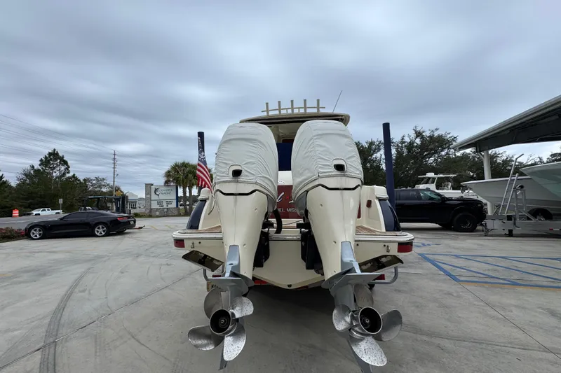 Slide: The Image of 2020 Chris-Craft Catalina 30 with dual outboard motors, parked in a marina. - 14