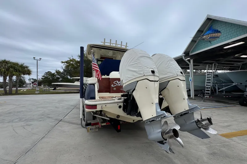 Slide: The Image of 2020 Chris-Craft Catalina 30 boat with dual outboard motors in a marina setting. - 15