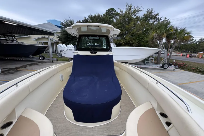Slide: The Image of 2020 Chris-Craft Catalina 30 boat with blue cover, docked outdoors. - 24