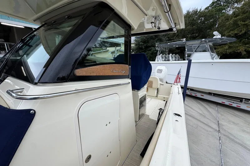 Slide: The Image of 2020 Chris-Craft Catalina 30 boat, docked with American flag, showcasing sleek design. - 26
