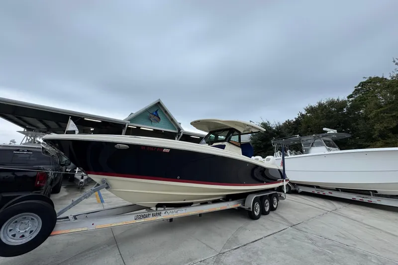 Slide: The Image of 2020 Chris-Craft Catalina 30 boat on trailer at marina, overcast sky. - 3