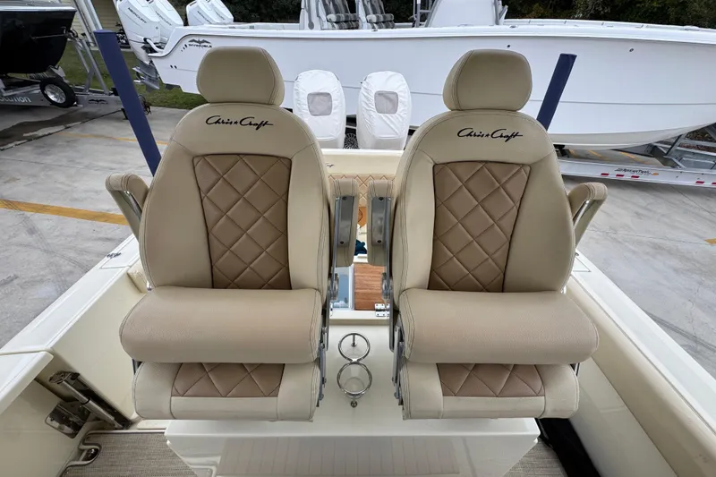 Slide: The Image of Luxurious seating on a 2020 Chris-Craft Catalina 30 boat, featuring elegant diamond-stitched upholstery. - 31