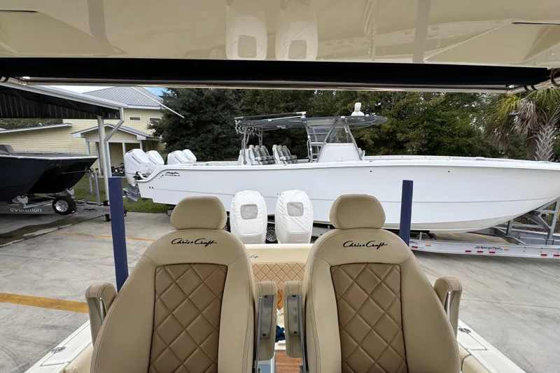 Slide: The Image of 2020 Chris-Craft Catalina 30 boat with luxurious seating, parked outdoors. - 32