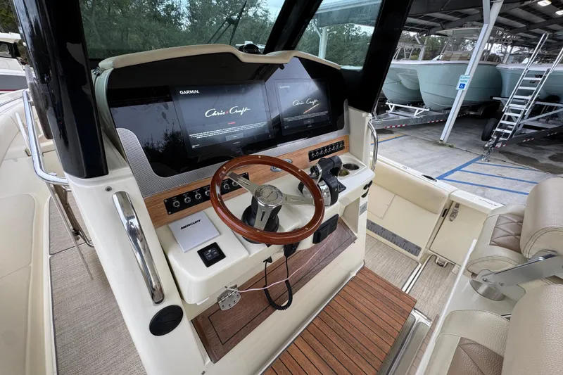Slide: The Image of 2020 Chris-Craft Catalina 30 helm with Garmin displays and wooden steering wheel. - 33