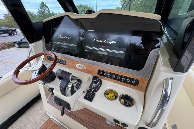 Slide: The Image of 2020 Chris-Craft Catalina 30 helm with dual Garmin displays and wooden steering wheel. - 36