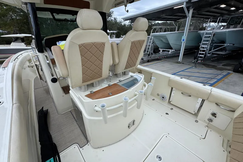 Slide: The Image of 2020 Chris-Craft Catalina 30 boat interior with beige seating and fishing rod holders. - 38