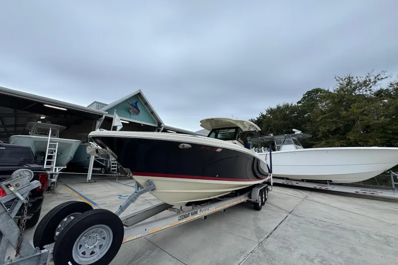 Slide: The Image of 2020 Chris-Craft Catalina 30 boat on trailer at marina, overcast sky. - 4